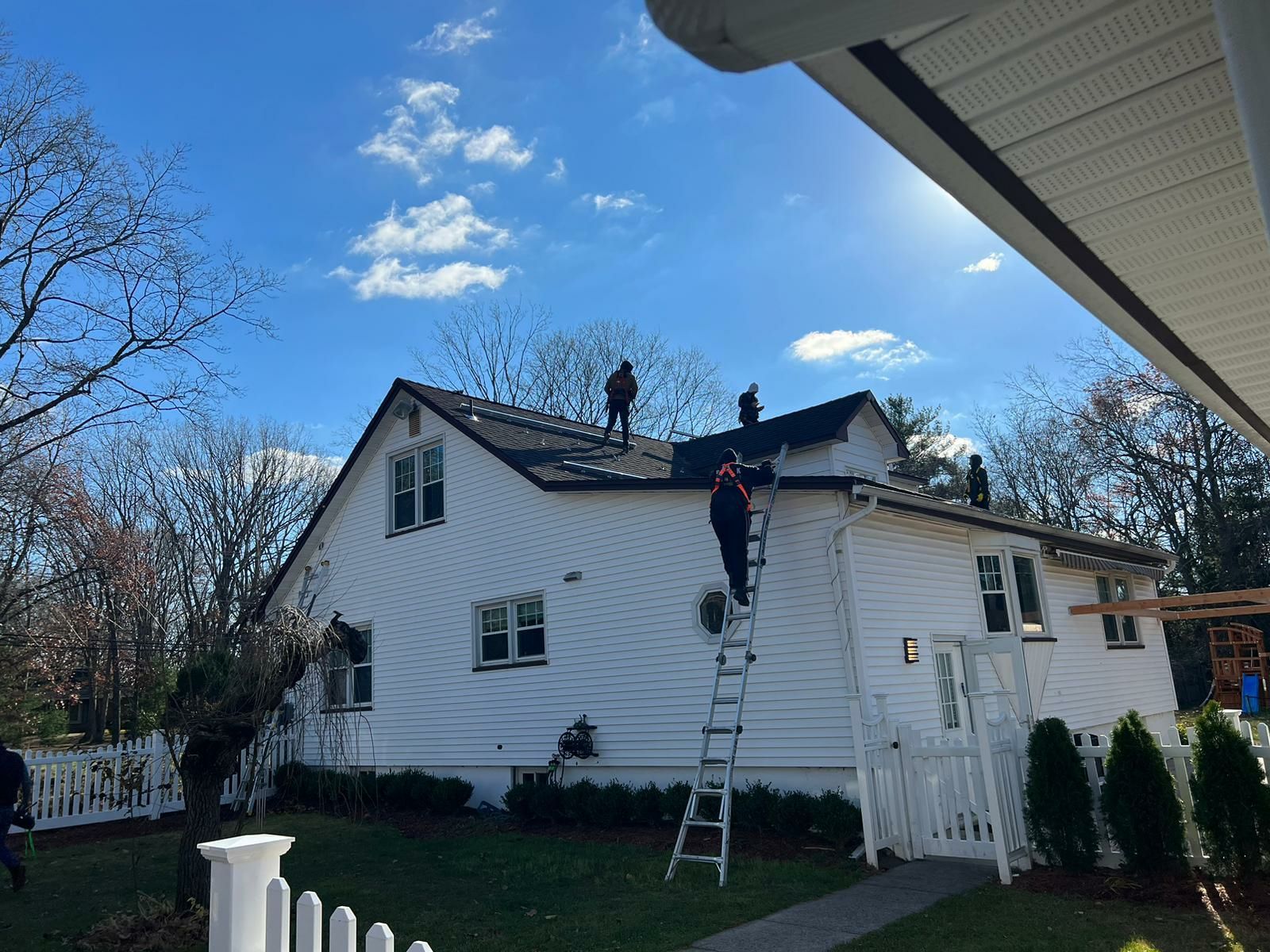 Crew installing solar panels on a roof in Toms River, NJ