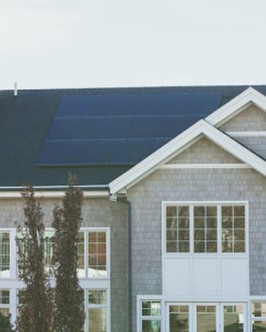Home with black solar panels across the roof